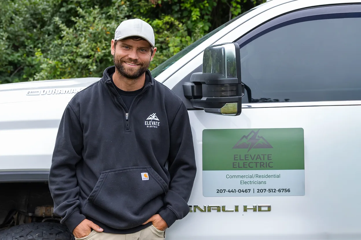 Justin Coull standing beside an Elevate Electric truck.