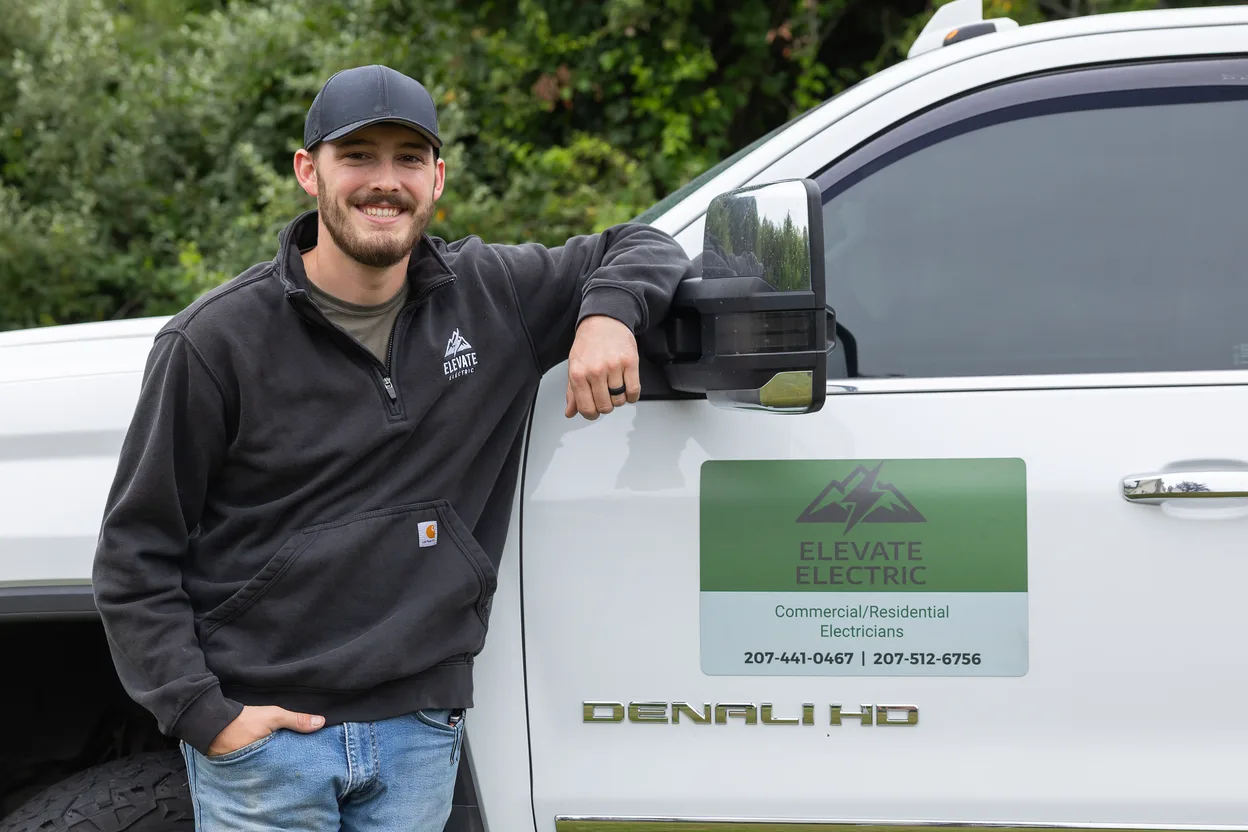 Sam McCray standing beside an Elevate Electric truck.