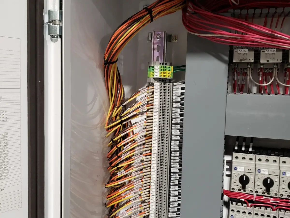 An industrial control panel with colour-coded wiring landed on terminal blocks.