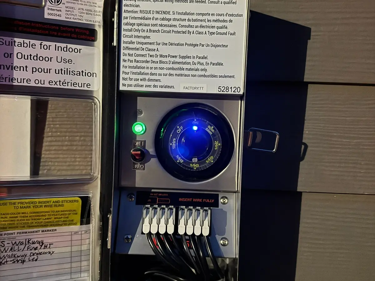 A wall-mounted EV charger installed on the exterior of a home.