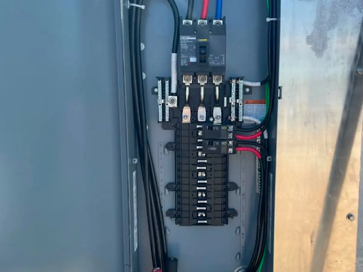 An open electrical panel with newly run circuit wiring neatly dressed and terminated.
